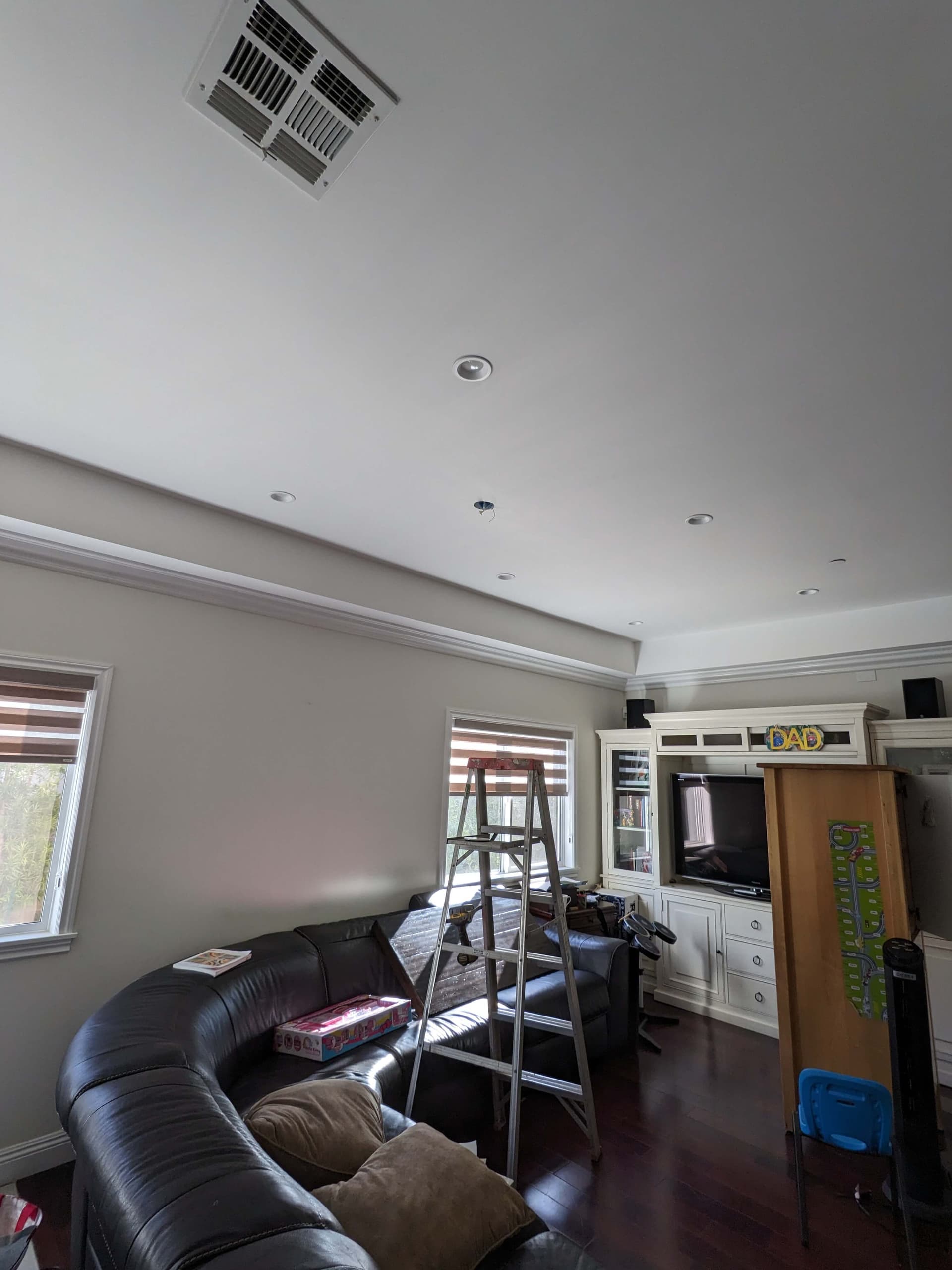 Old ceiling fan before professional replacement during lighting project