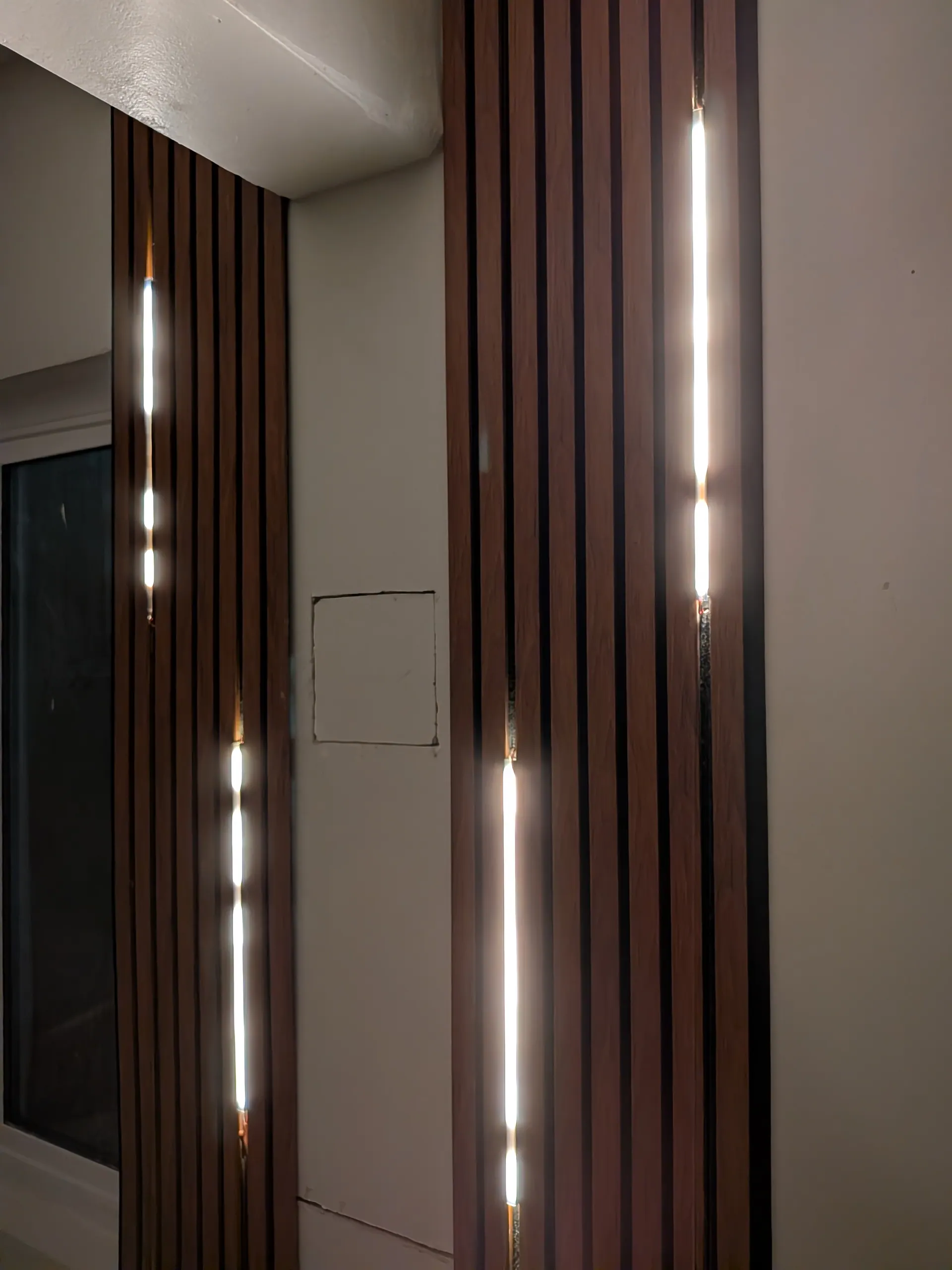 Wall-mounted LED strip light accent installation by RnR Electrician